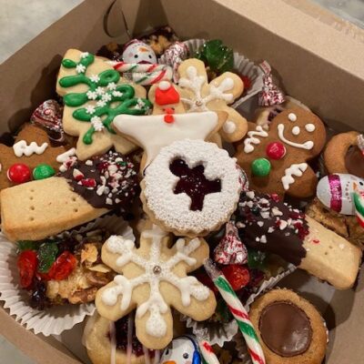 Festive box of holiday cookies and squares, handmade gingerbread men, sugar cookies