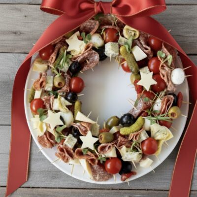 decorative charcuterie wreath with skewers of meat/cheese/pickles/olives