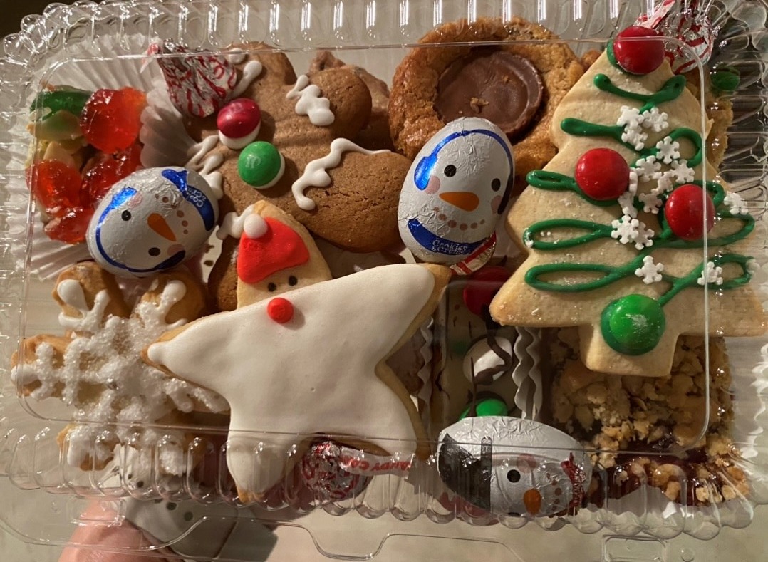 festive holiday cookie and squares in a box and tied with ribbon